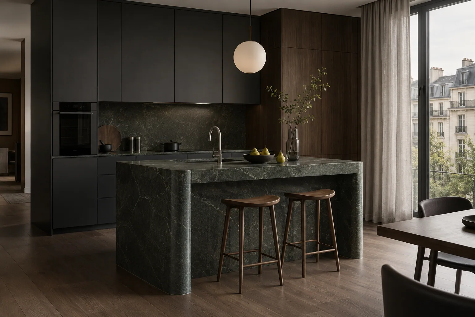 Charcoal kitchen with a dark green stone island and walnut stools.
